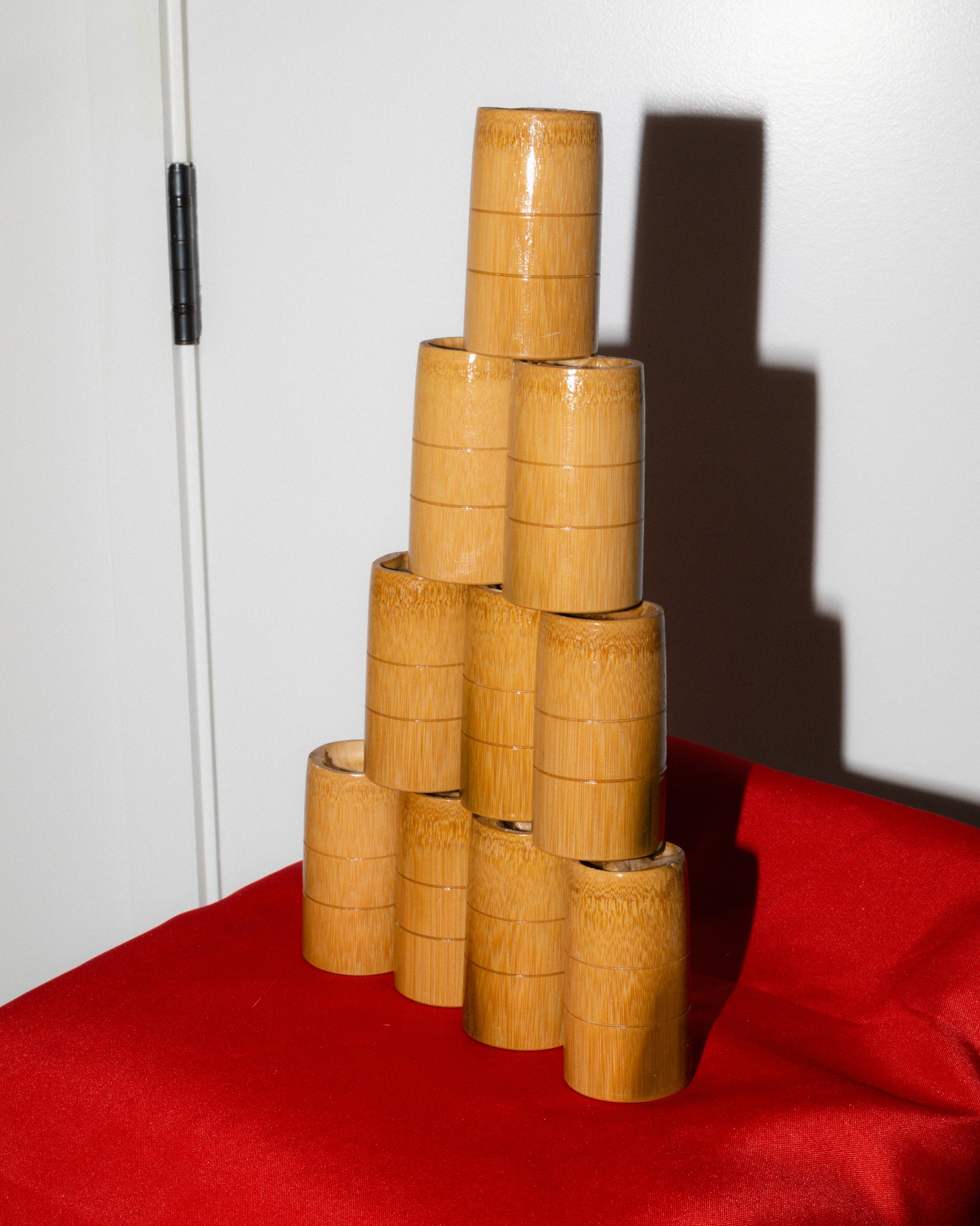 A stack of cylindrical containers casting a shadow on a wall.